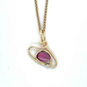 Pink sapphire and diamond pendant